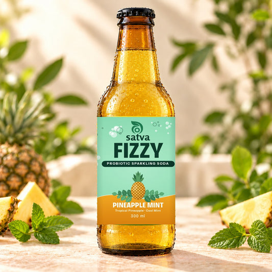 Satva Fizzy Pineapple Mint probiotic sparkling soda in an amber 300 ml bottle with pineapple slices and mint
